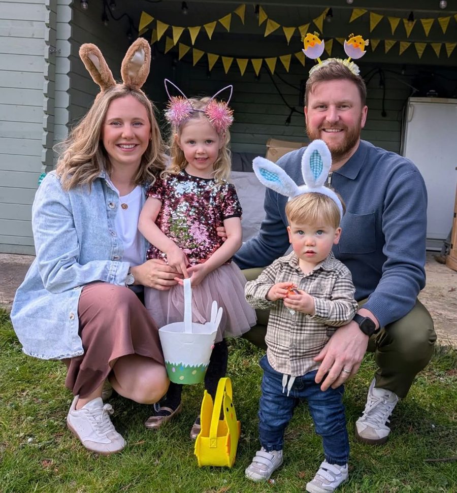 Harry Palmer with his wife and two children in the garden, all wearing Easter bunny ears